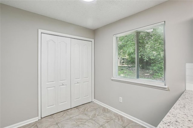 1050 Chapman Cir, Stone Mountain, GA 30088 - unfurnished bedroom with a closet and a textured ceiling