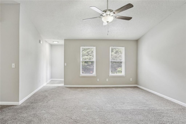 1050 Chapman Cir, Stone Mountain, GA 30088 - spare room featuring a textured ceiling, ceiling fan, and carpet flooring