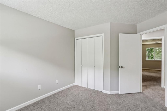 1050 Chapman Cir, Stone Mountain, GA 30088 - unfurnished bedroom featuring carpet floors, a textured ceiling, and a closet