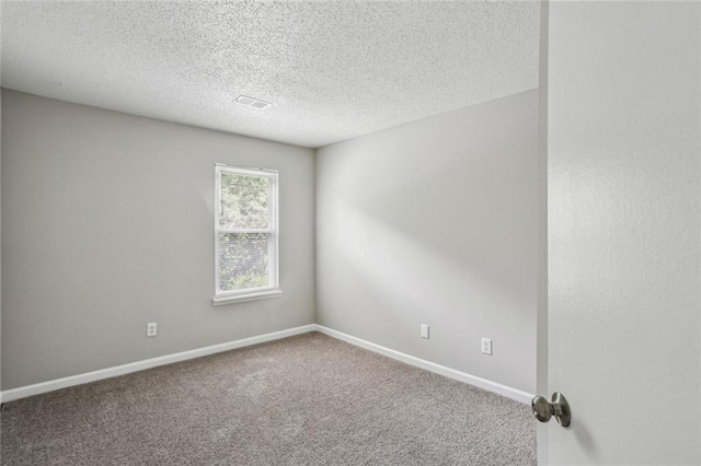 1050 Chapman Cir, Stone Mountain, GA 30088 - carpeted spare room featuring a textured ceiling and baseboards