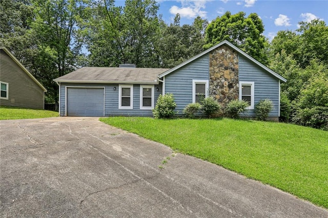 1050 Chapman Cir, Stone Mountain, GA 30088 - view of front of house featuring an attached garage, concrete driveway, and a front lawn