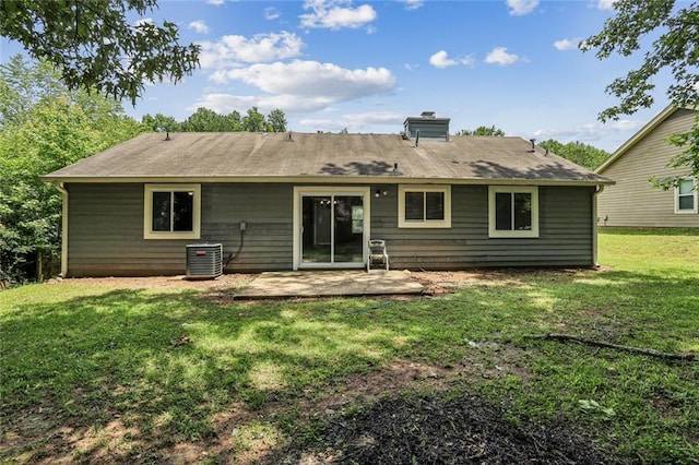 1050 Chapman Cir, Stone Mountain, GA 30088 - rear view of house with a chimney, a lawn, and a patio