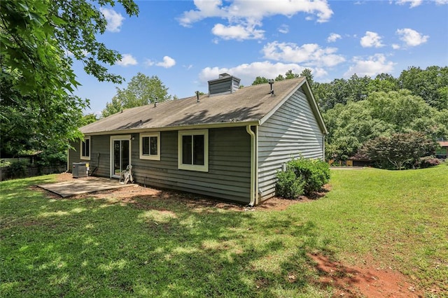 1050 Chapman Cir, Stone Mountain, GA 30088 - rear view of house with a patio area, a lawn, and a chimney