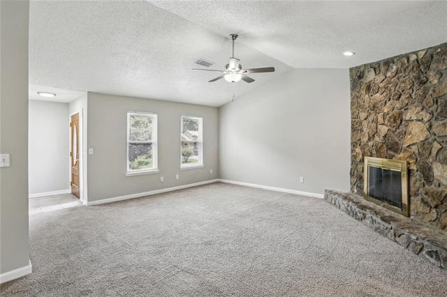 1050 Chapman Cir, Stone Mountain, GA 30088 - unfurnished living room with ceiling fan, carpet, vaulted ceiling, a fireplace, and a textured ceiling