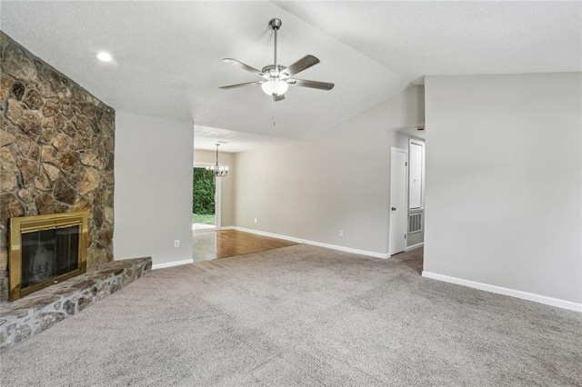 1050 Chapman Cir, Stone Mountain, GA 30088 - unfurnished living room with ceiling fan, carpet floors, a chandelier, vaulted ceiling, and a fireplace