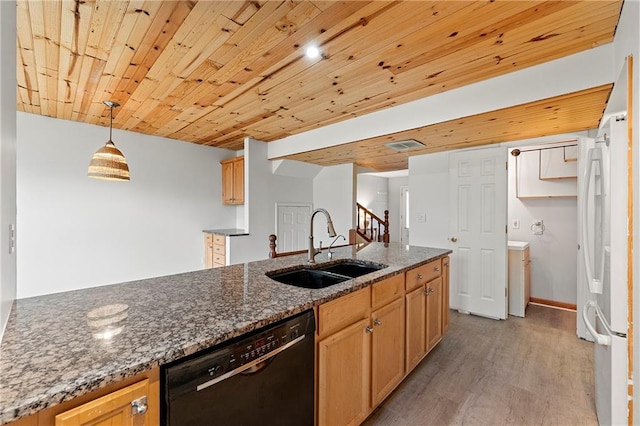 kitchen featuring pendant lighting, sink, black dishwasher, dark stone countertops, and white fridge