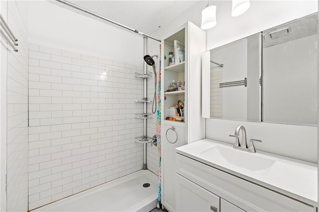 bathroom featuring vanity and a tile shower