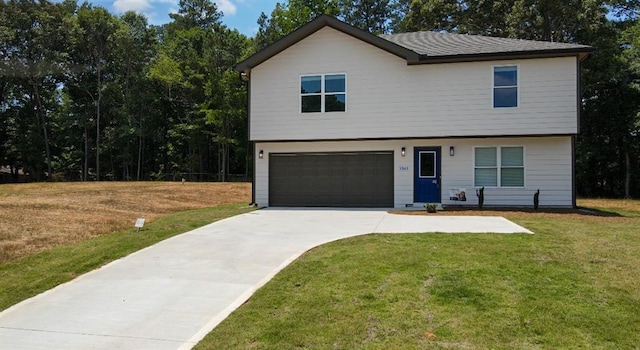 1341 E Atlanta Rd E, Stockbridge, GA 30281 - view of front of home with a garage, concrete driveway, and a front yard