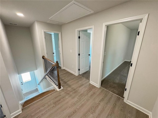1341 E Atlanta Rd E, Stockbridge, GA 30281 - hallway with an upstairs landing, attic access, wood finished floors, and baseboards