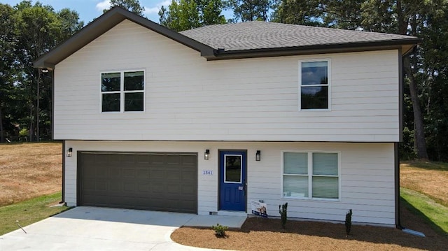 1341 E Atlanta Rd E, Stockbridge, GA 30281 - view of front of property with an attached garage, concrete driveway, and a shingled roof