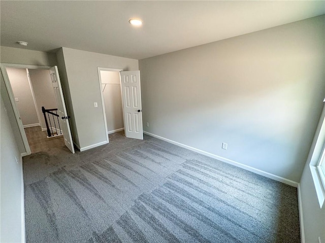 1341 E Atlanta Rd E, Stockbridge, GA 30281 - unfurnished bedroom with dark colored carpet, baseboards, a closet, and recessed lighting