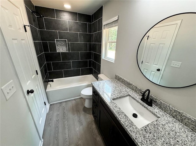 1341 E Atlanta Rd E, Stockbridge, GA 30281 - bathroom with vanity, wood finished floors, toilet, and shower / washtub combination