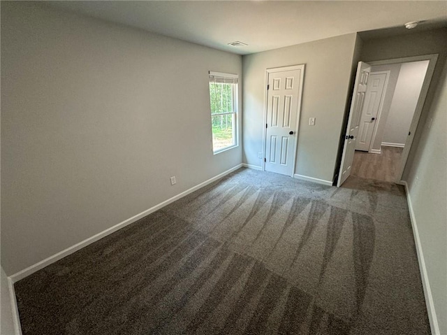 1341 E Atlanta Rd E, Stockbridge, GA 30281 - unfurnished bedroom with baseboards and carpet flooring
