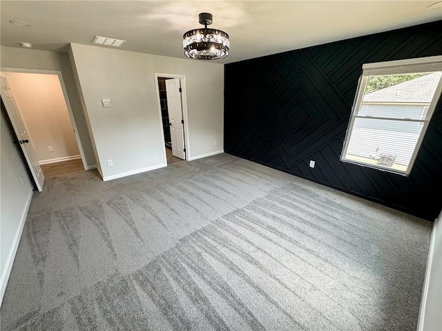 1341 E Atlanta Rd E, Stockbridge, GA 30281 - carpeted empty room with baseboards and a chandelier