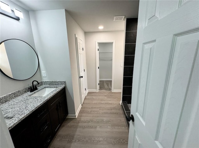 1341 E Atlanta Rd E, Stockbridge, GA 30281 - full bath with vanity, wood finished floors, baseboards, and recessed lighting