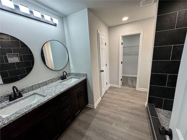 1341 E Atlanta Rd E, Stockbridge, GA 30281 - full bath with double vanity, wood finished floors, recessed lighting, a spacious closet, and baseboards