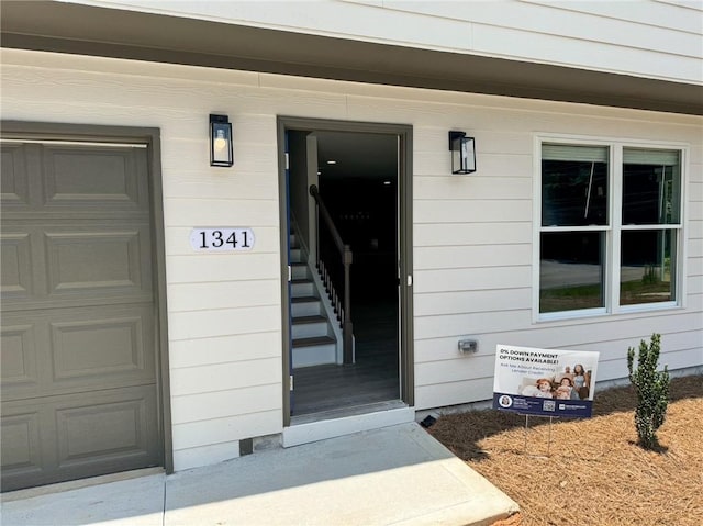 1341 E Atlanta Rd E, Stockbridge, GA 30281 - view of exterior entry featuring a garage