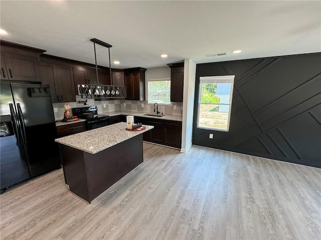 1341 E Atlanta Rd E, Stockbridge, GA 30281 - kitchen with black fridge, range with electric cooktop, a sink, light wood-style floors, and dark brown cabinetry