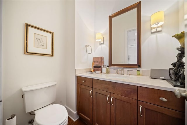 bathroom featuring toilet and vanity