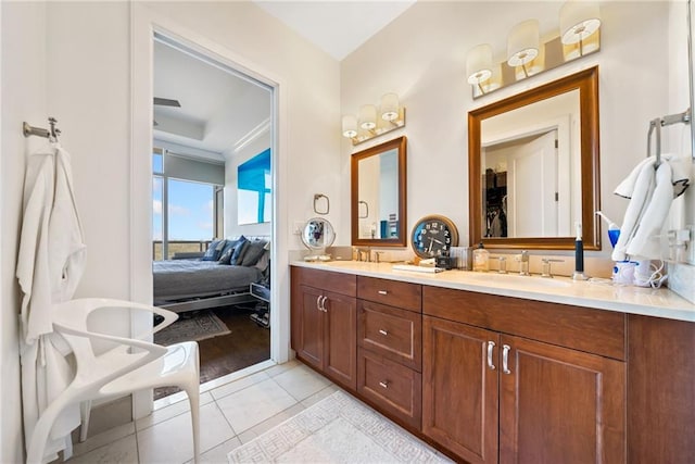 bathroom with ornamental molding, tile patterned flooring, and vanity