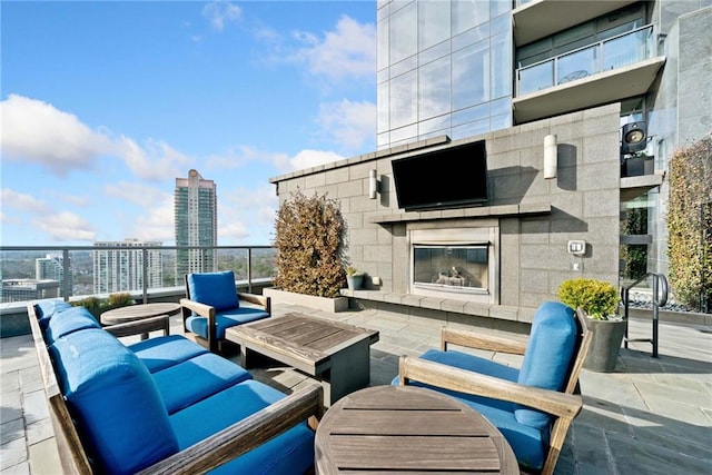 view of patio featuring an outdoor living space with a fireplace