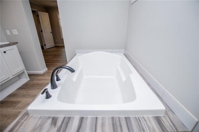 74 Preacher Smith Rd, Silver Creek, GA 30173 - full bath with a garden tub, vanity, and wood finished floors