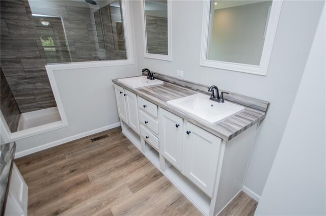 74 Preacher Smith Rd, Silver Creek, GA 30173 - bathroom featuring double vanity, wood finished floors, walk in shower, and baseboards