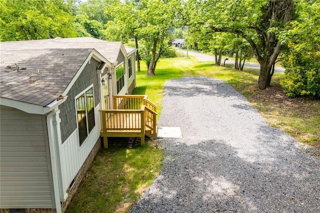 74 Preacher Smith Rd, Silver Creek, GA 30173 - view of side of home featuring a shingled roof, a yard, and view of wooded area