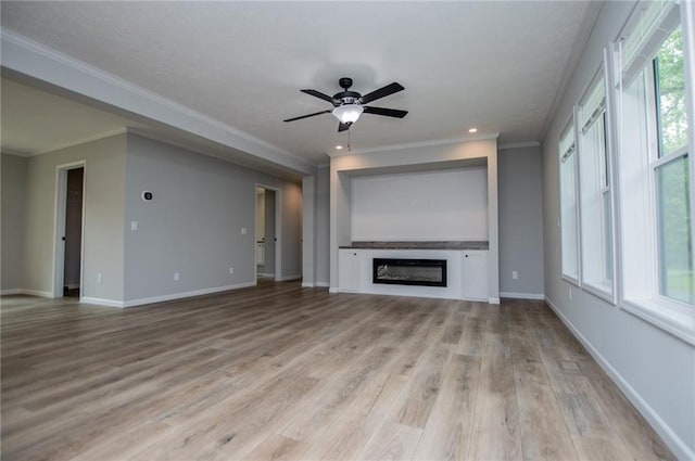 74 Preacher Smith Rd, Silver Creek, GA 30173 - unfurnished living room with ornamental molding, light wood-style flooring, a glass covered fireplace, baseboards, and a ceiling fan