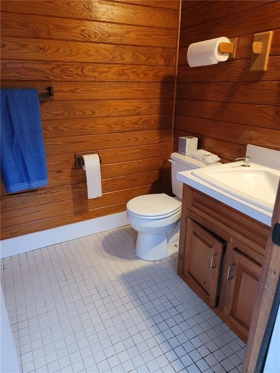 2900 Orchard Rd SW, Conyers, GA 30094 - bathroom featuring vanity, toilet, wooden walls, and tile patterned flooring