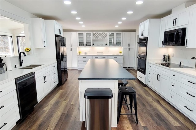 2900 Orchard Rd SW, Conyers, GA 30094 - kitchen featuring black appliances, a sink, a kitchen bar, a center island, and recessed lighting