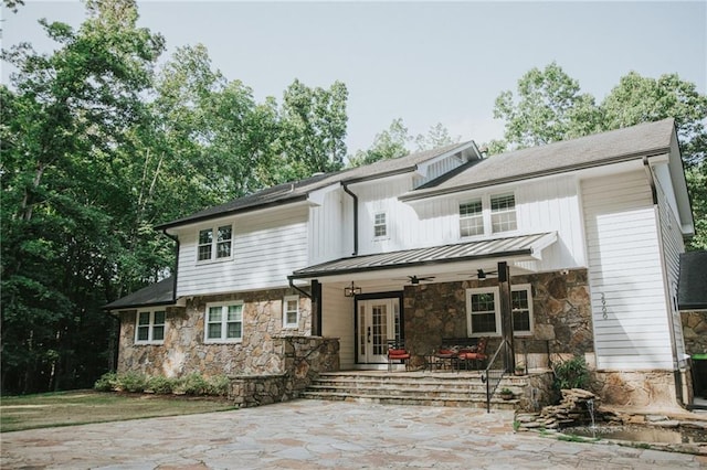 2900 Orchard Rd SW, Conyers, GA 30094 - rear view of house featuring stone siding, a ceiling fan, a standing seam roof, covered porch, and metal roof