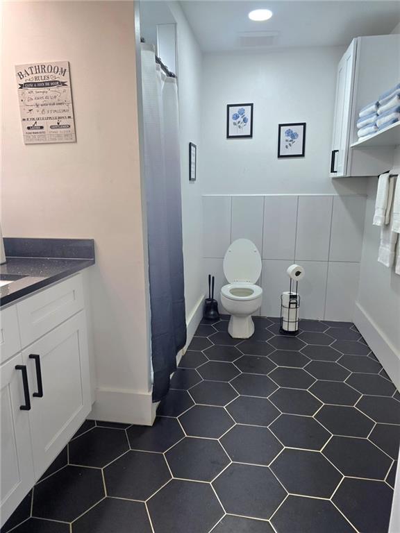 2900 Orchard Rd SW, Conyers, GA 30094 - full bathroom with toilet, vanity, a shower with curtain, and tile patterned floors