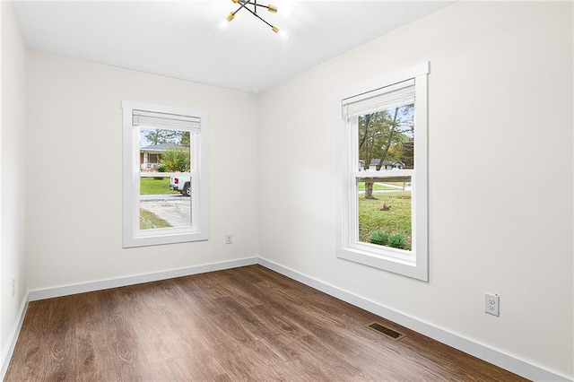 578 Cedar Ave, Atlanta, GA 30318 - empty room featuring a healthy amount of sunlight, dark wood-style flooring, baseboards, and visible vents