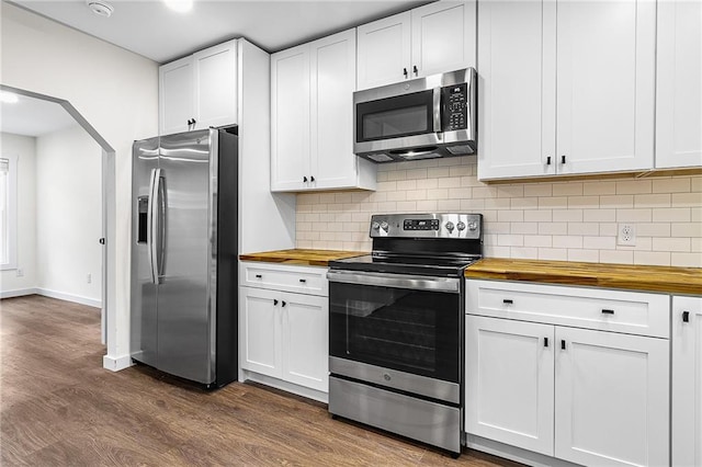 578 Cedar Ave, Atlanta, GA 30318 - kitchen featuring tasteful backsplash, dark wood-style flooring, white cabinetry, butcher block counters, and appliances with stainless steel finishes