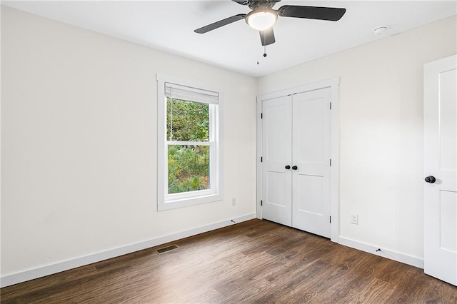 578 Cedar Ave, Atlanta, GA 30318 - unfurnished bedroom with ceiling fan, dark wood finished floors, a closet, visible vents, and baseboards