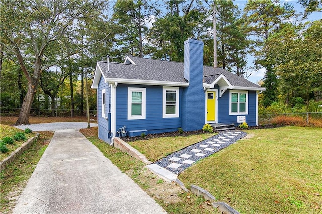 578 Cedar Ave, Atlanta, GA 30318 - view of front of home featuring roof with shingles, fence, a front lawn, a chimney, and driveway