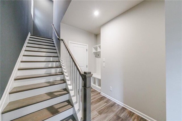 stairway with hardwood / wood-style floors