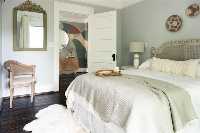 bedroom featuring dark wood-type flooring and ornamental molding