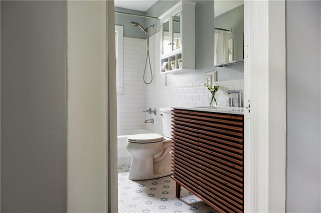 full bathroom with shower / tub combo with curtain, tile patterned flooring, toilet, backsplash, and vanity