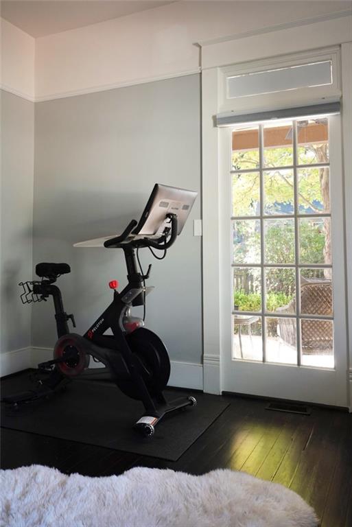 workout room with dark hardwood / wood-style flooring