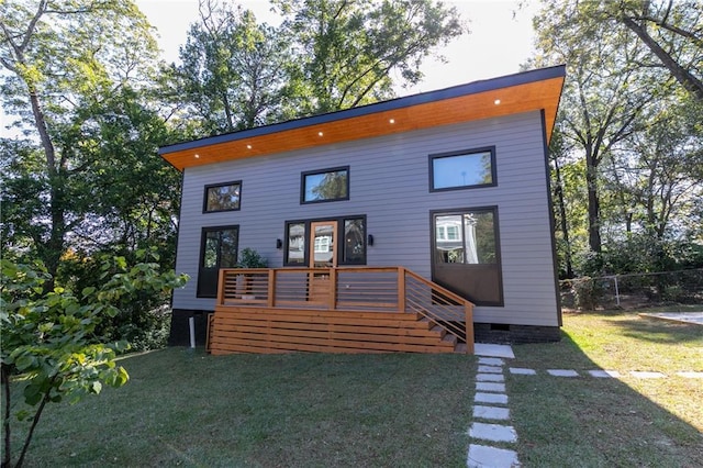 contemporary home with a deck and a front lawn