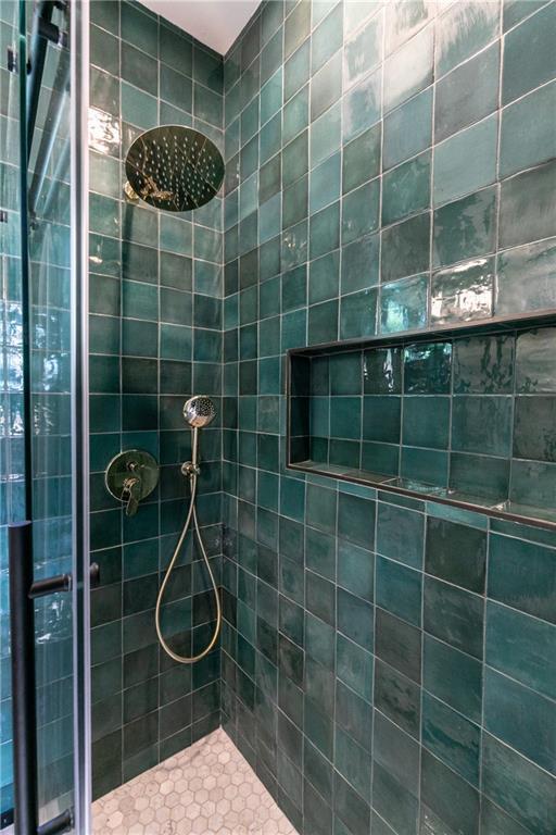 bathroom with a tile shower