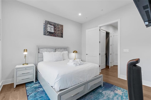 bedroom with hardwood / wood-style floors