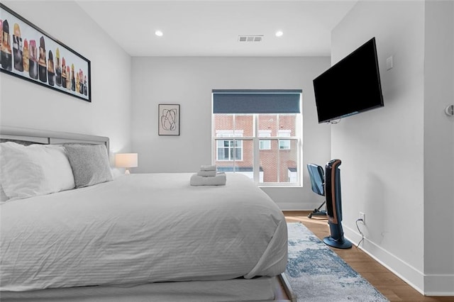 bedroom with hardwood / wood-style floors