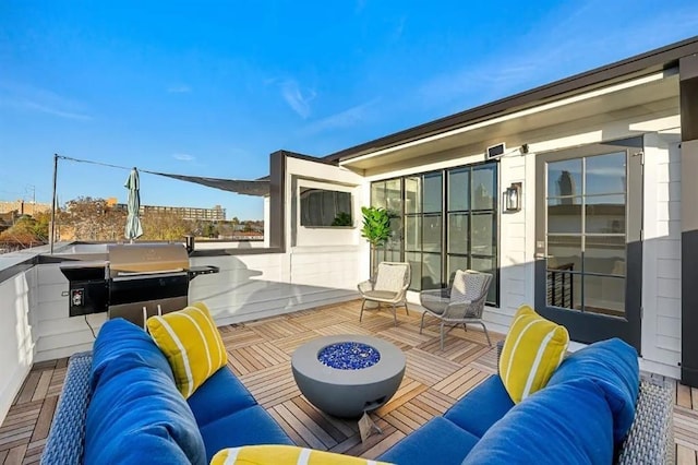 view of patio / terrace featuring an outdoor living space with a fire pit and a balcony