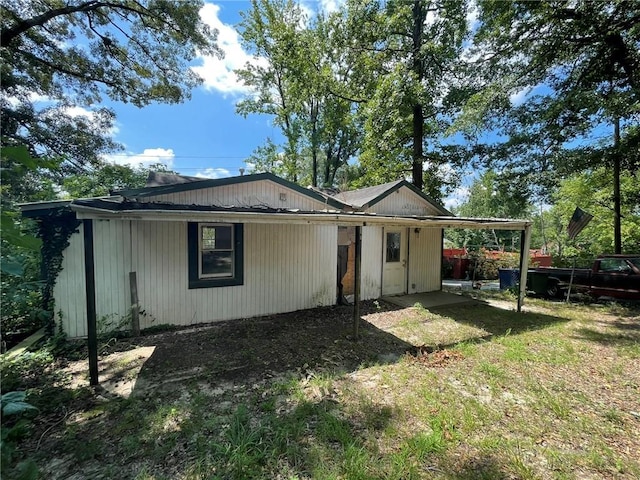 back of property featuring a carport