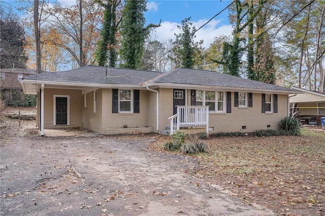 ranch-style house featuring a carport