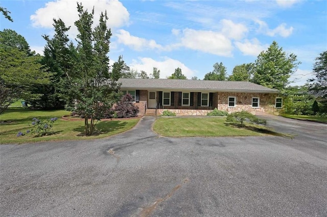 6880 Mark Turner Rd, Lithia Springs, GA 30122 - ranch-style house featuring stone siding, asphalt driveway, and a front yard