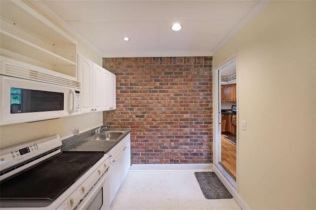 6880 Mark Turner Rd, Lithia Springs, GA 30122 - kitchen featuring white appliances, brick wall, white cabinets, crown molding, and dark countertops